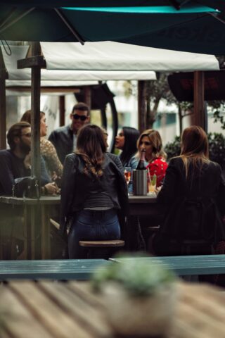 People sitting by a table at a terrace